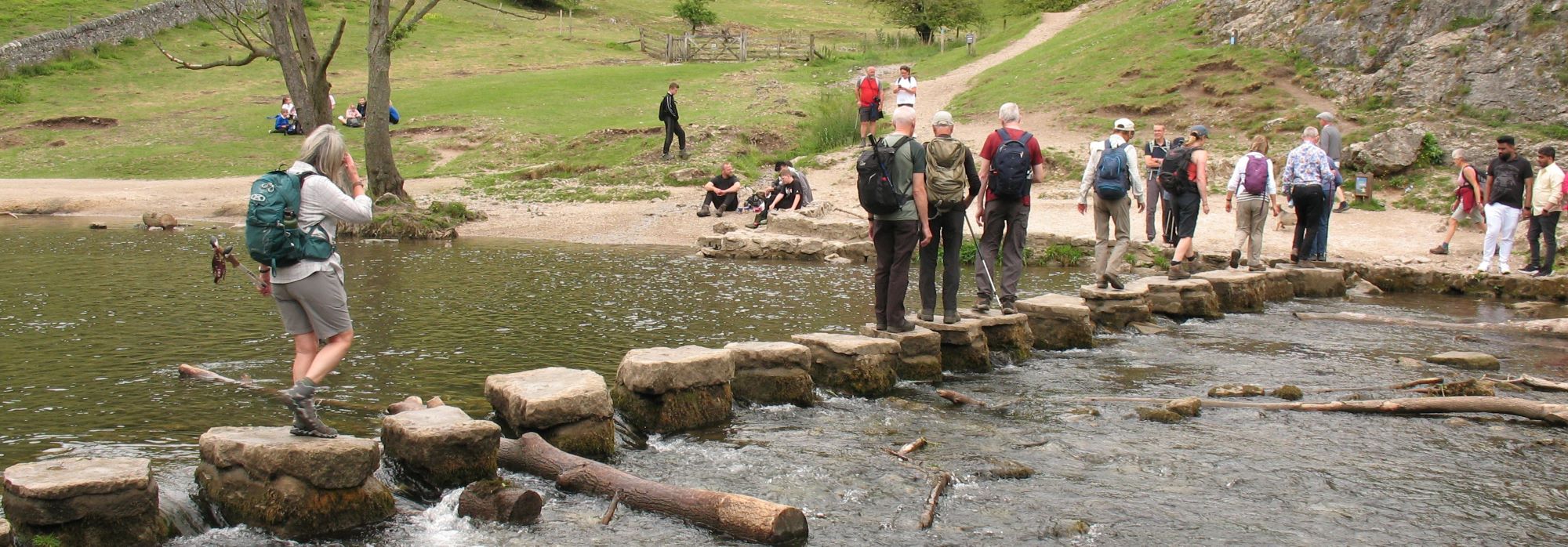 walkers crossing dovedale stepping stones